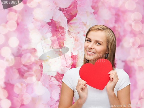 Image of smiling woman in white t-shirt with heart