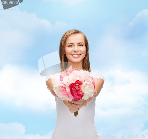 Image of smiling woman with bouquet of flowers