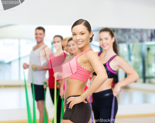 Image of personal trainer with group in gym