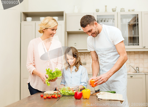 Image of happy family making dinner in kitchen