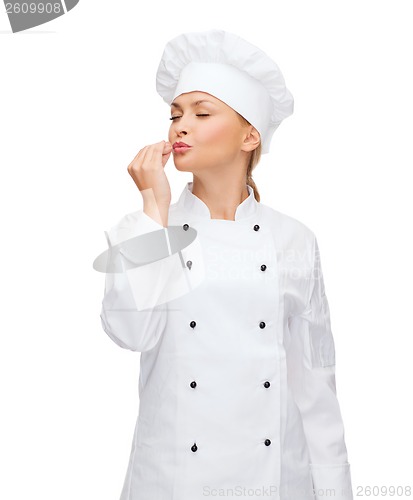 Image of smiling female chef showing delicious sign