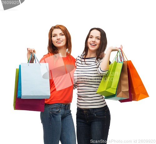 Image of two smiling teenage girls with shopping bags