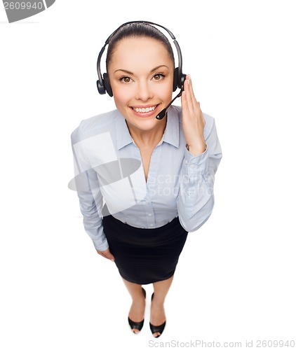 Image of friendly female helpline operator with headphones