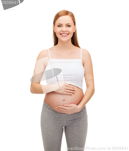 Image of happy future mother touching her belly