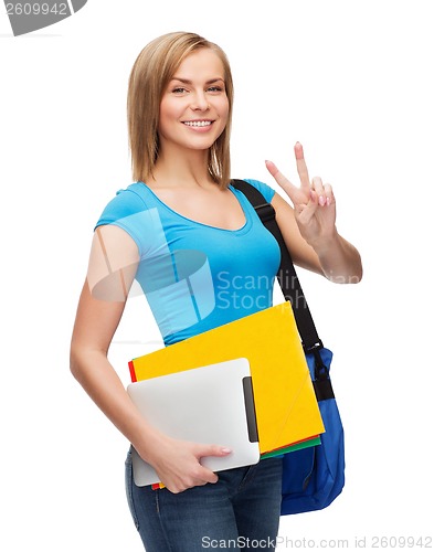 Image of female student with bag, tablet pc and folders