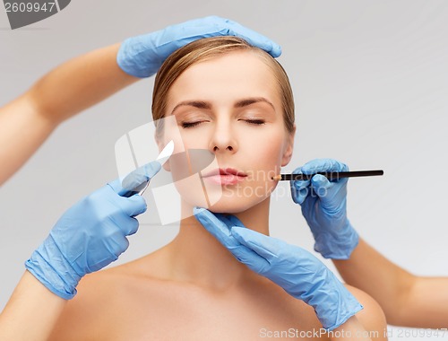 Image of woman face and beautician hands with pencil