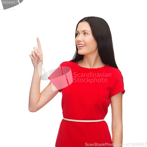 Image of young woman in red dress pointing her finger