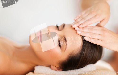 Image of beautiful woman in spa salon having facial