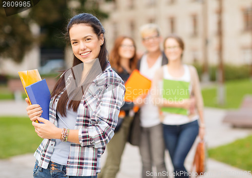 Image of teenage girl with folders and mates on the back