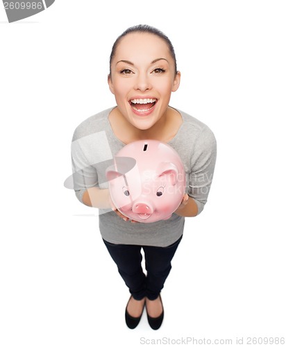 Image of laughing woman with piggy bank