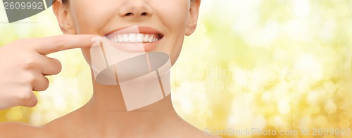 Image of beautiful woman pointing to teeth