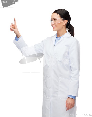 Image of smiling female doctor pointing to something