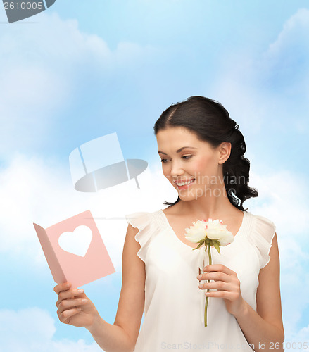 Image of young woman holding flower and postcard