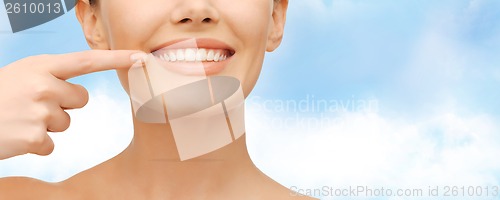 Image of beautiful woman pointing to teeth