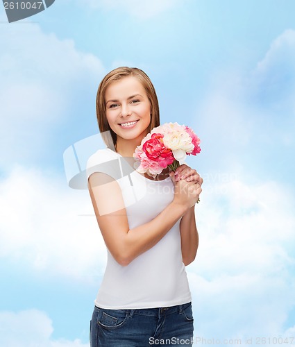 Image of smiling woman with bouquet of flowers