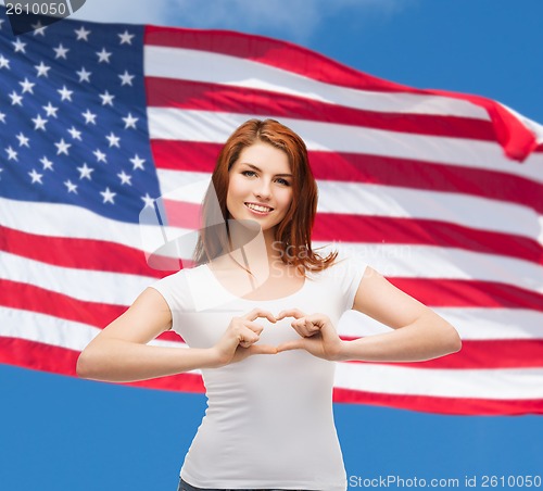 Image of smiling girl showing heart with hands