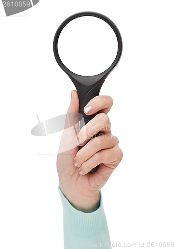 Image of woman hand holding magnifying glass