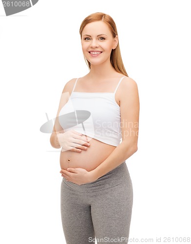 Image of happy future mother touching her belly