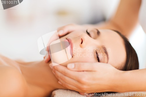 Image of beautiful woman in spa salon having facial