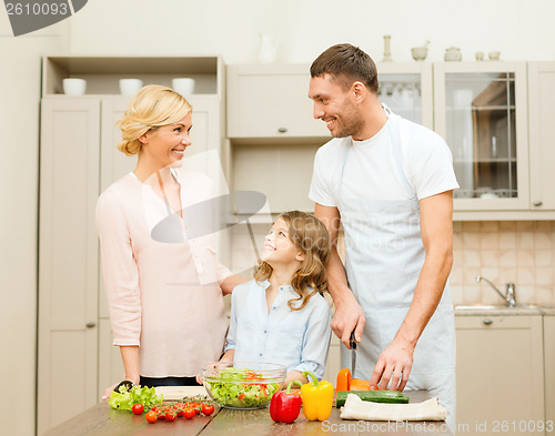 Image of happy family making dinner in kitchen