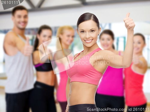 Image of personal trainer with group in gym