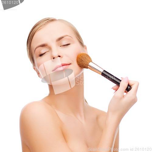 Image of beautiful woman with makeup brush