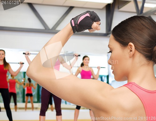 Image of beautiful sporty woman in gym