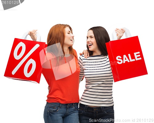 Image of two smiling teenage girl with shopping bags