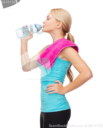 Image of sporty woman with towel and watel bottle