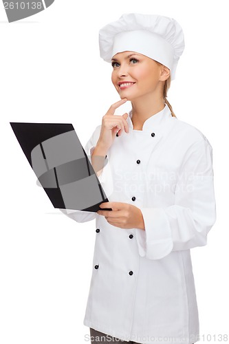 Image of smiling female chef with black blank paper