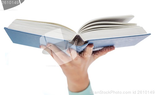 Image of close up of woman hand holding open book