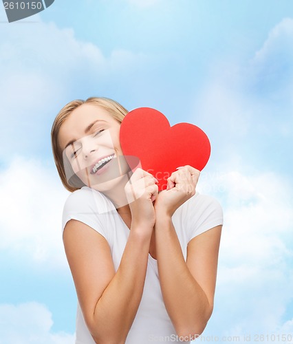 Image of smiling woman in white t-shirt with heart