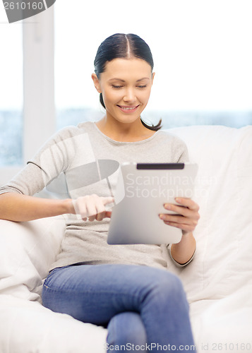 Image of smiling woman with tablet pc computer at home