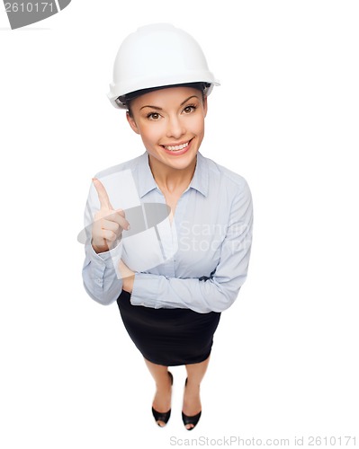 Image of businesswoman in white helmet with finger up