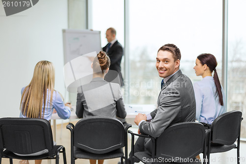 Image of businessman with team in office