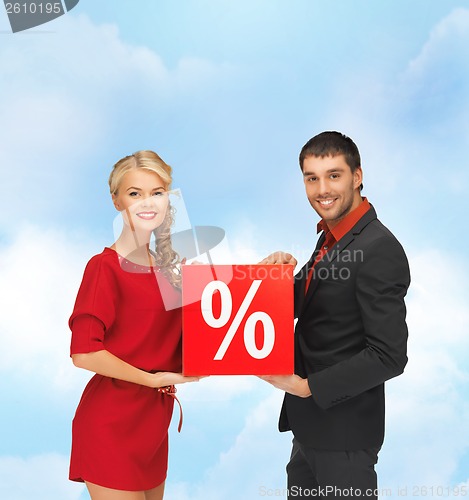 Image of smiling man and woman with percent sign