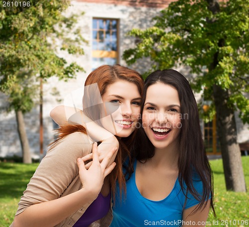 Image of two laughing girls hugging