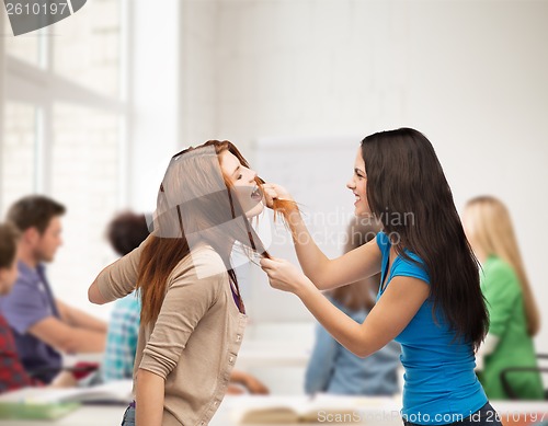 Image of two teenagers having a fight and getting physical