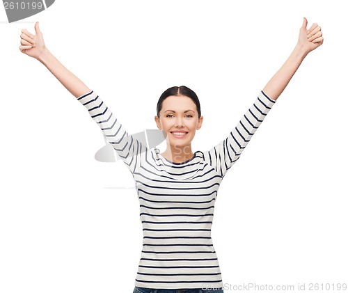 Image of smiling girl in casual clother showing thumbs up