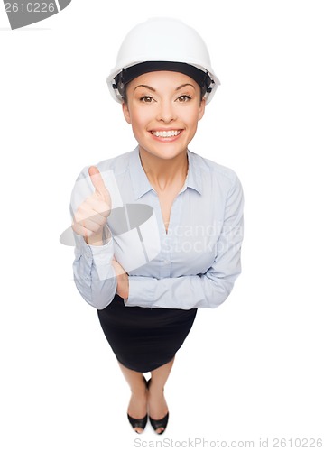 Image of businesswoman in white helmet showing thumbs up