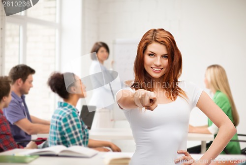 Image of teenager at school in t-shirt pointing at you