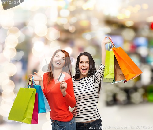 Image of teenage girls with shopping bags and credit card