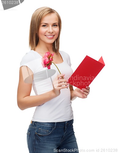 Image of smiling girl with postcard and flower