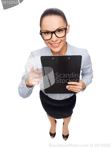 Image of smiling businesswoman in eyeglasses with clipboard