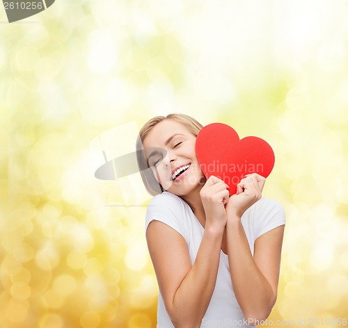 Image of smiling woman in white t-shirt with heart