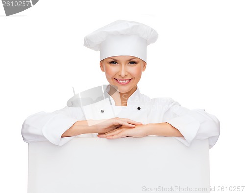 Image of smiling female chef with white blank board