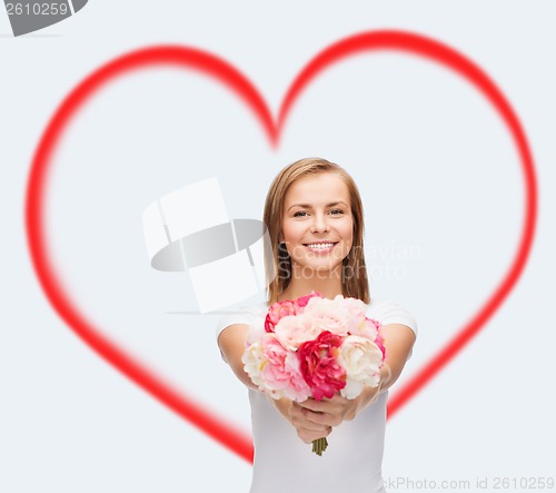 Image of smiling woman with bouquet of flowers