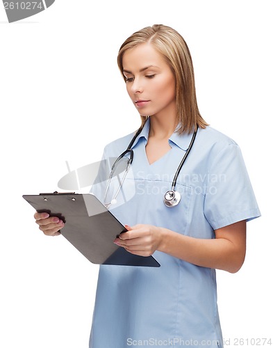 Image of smiling female doctor or nurse with clipboard