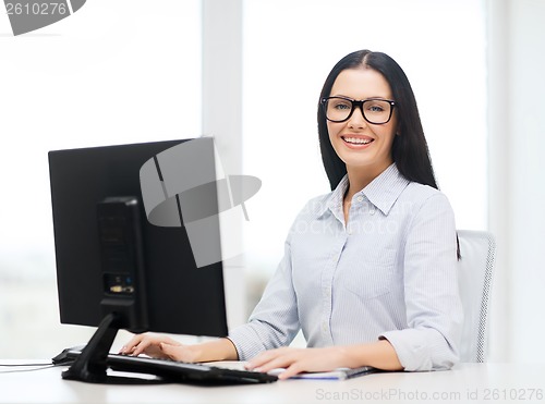 Image of smiling businesswoman or student with eyeglasses