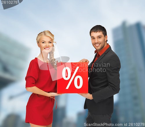 Image of smiling man and woman with percent sign